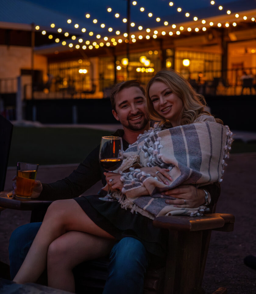 Couple sitting together outdoors at night