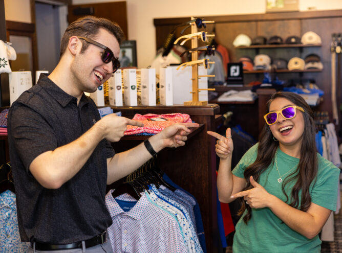 two people smiling and shopping in store