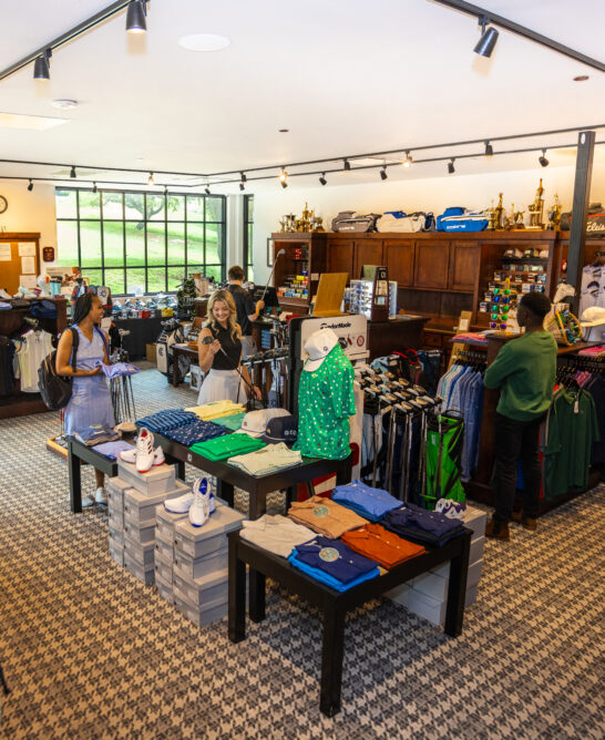 The interior of a busy retail store with clothing and merchandise on display.