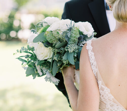 A wedded couple holding flowers