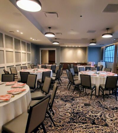 banquet room with round tables and white tablecloths