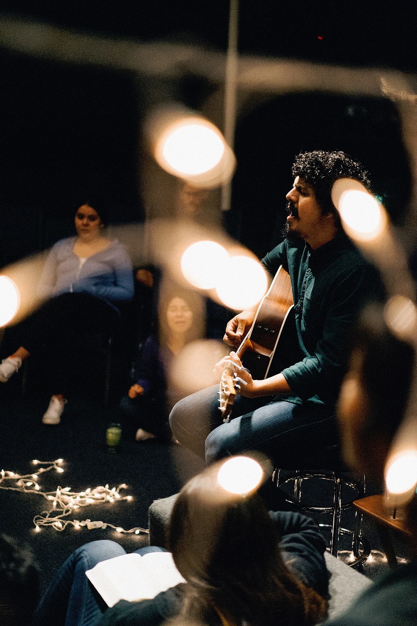 musician playing guitar on stage