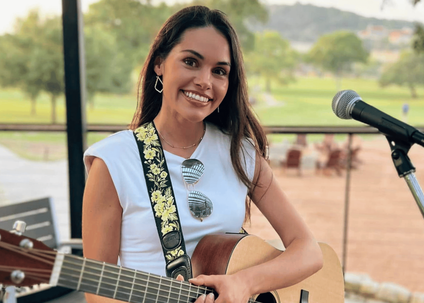 Female musician with guitar on patio