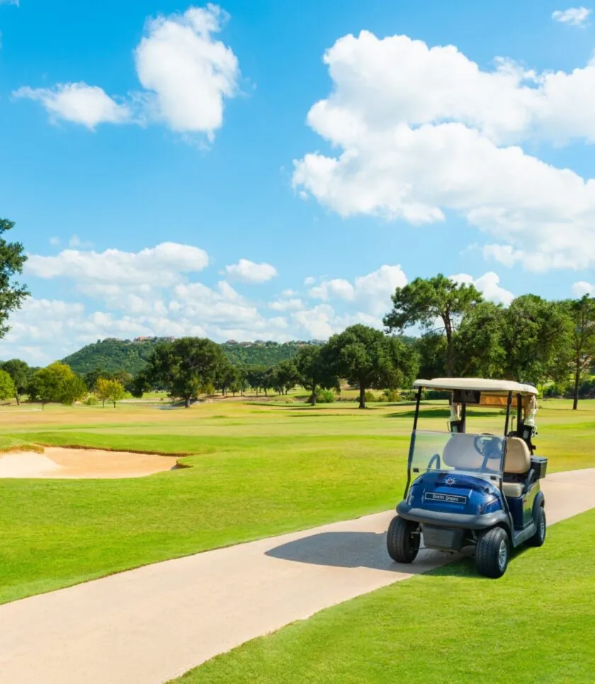 Golf cart driving on green course