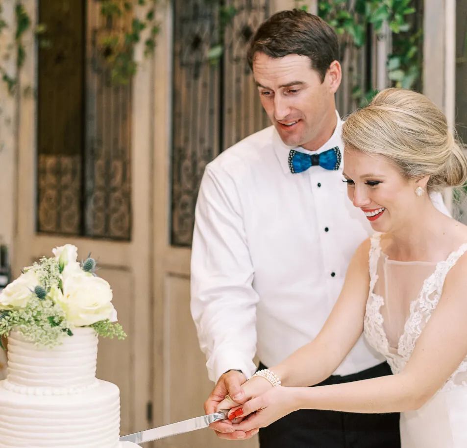 bride and groom cutting wedding cake