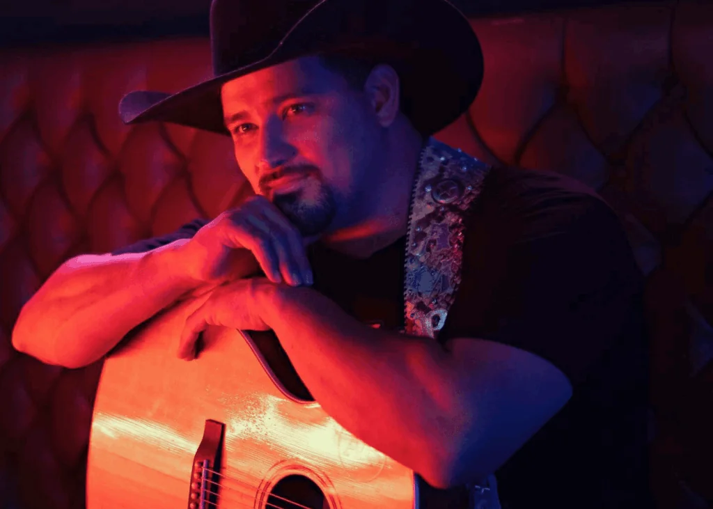 Man with guitar and cowboy hat